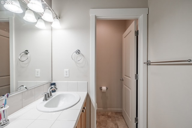 bathroom featuring baseboards and vanity