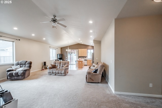 living room with recessed lighting, vaulted ceiling, light colored carpet, and ceiling fan with notable chandelier