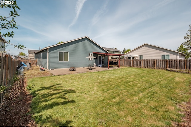 back of property featuring a lawn, a fenced backyard, and a patio area