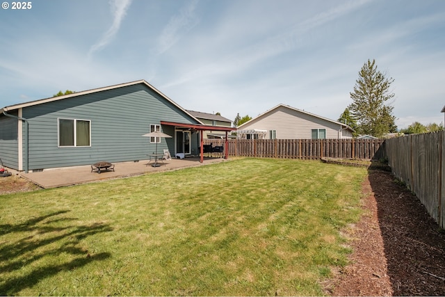 rear view of house with a fenced backyard, a patio, and a yard