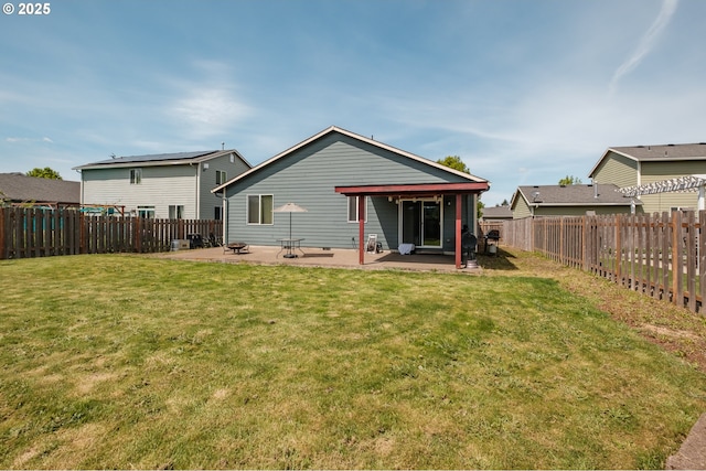rear view of property with a fenced backyard, a patio, and a yard