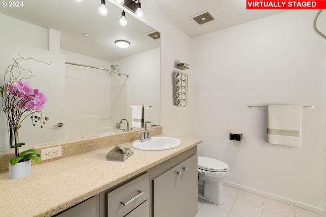 bathroom featuring tile patterned flooring, toilet, vanity, visible vents, and baseboards