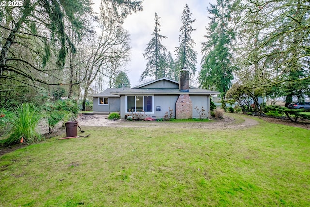 rear view of house featuring a lawn