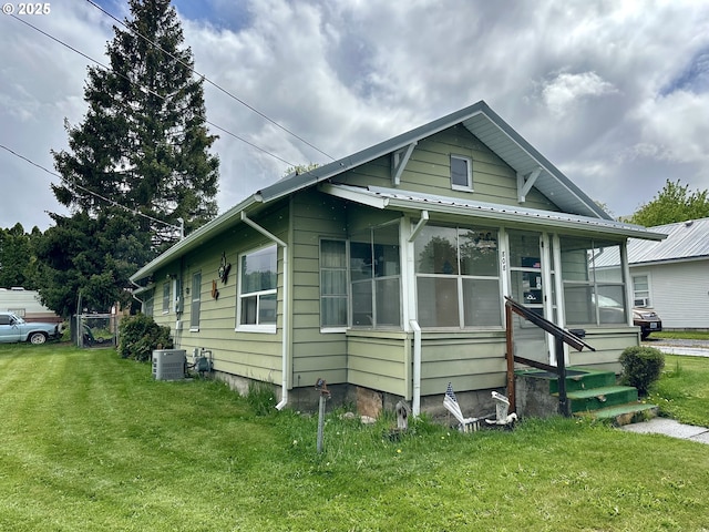 808 F Ave, La Grande, OR 97850 - view of property exterior featuring a yard, a sunroom, and metal roof