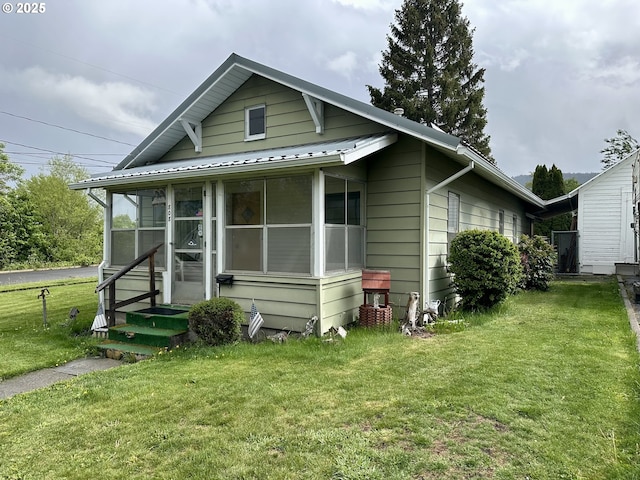 808 F Ave, La Grande, OR 97850 - view of front facade featuring a sunroom, a front lawn, and metal roof