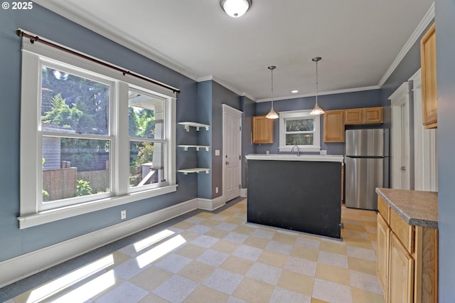 3607 NE 13th Ave, Portland, OR 97212 - kitchen featuring freestanding refrigerator, a kitchen island, baseboards, decorative light fixtures, and a sink