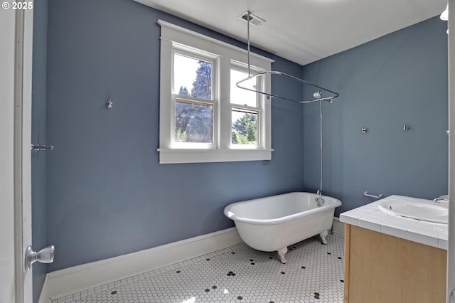 3607 NE 13th Ave, Portland, OR 97212 - bathroom featuring a freestanding bath, baseboards, vanity, tile patterned flooring, and a shower