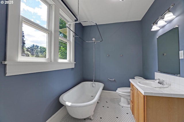 3607 NE 13th Ave, Portland, OR 97212 - bathroom featuring baseboards, vanity, toilet, and tile patterned floors