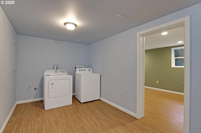 3607 NE 13th Ave, Portland, OR 97212 - washroom with washing machine and dryer, light wood-type flooring, baseboards, recessed lighting, and a textured ceiling