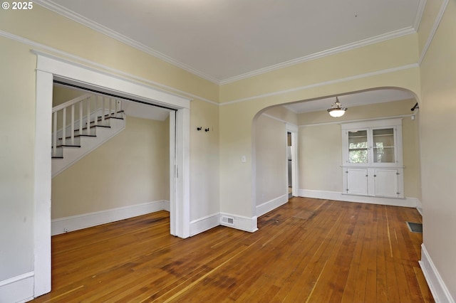 3607 NE 13th Ave, Portland, OR 97212 - spare room featuring arched walkways, hardwood / wood-style flooring, crown molding, and baseboards