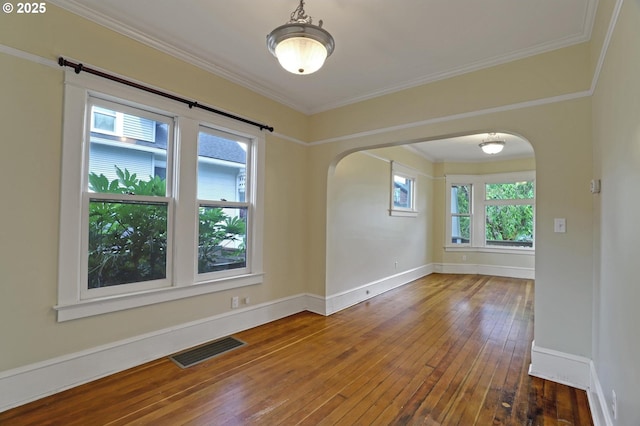 3607 NE 13th Ave, Portland, OR 97212 - empty room with wood-type flooring, arched walkways, baseboards, and crown molding