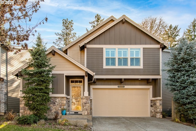 craftsman house with board and batten siding, stone siding, a garage, and concrete driveway