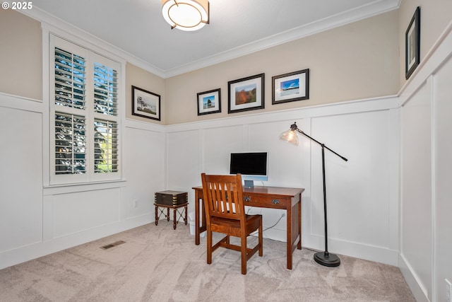 office area featuring ornamental molding, carpet flooring, visible vents, and a decorative wall