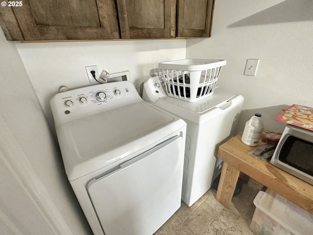 washroom featuring cabinet space and washer and dryer