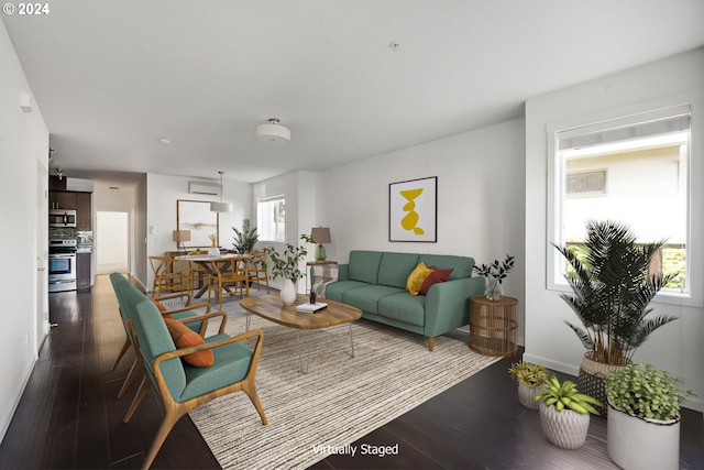 living room featuring dark wood-type flooring and plenty of natural light