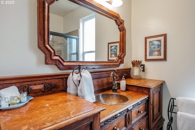 full bath featuring a stall shower and vanity