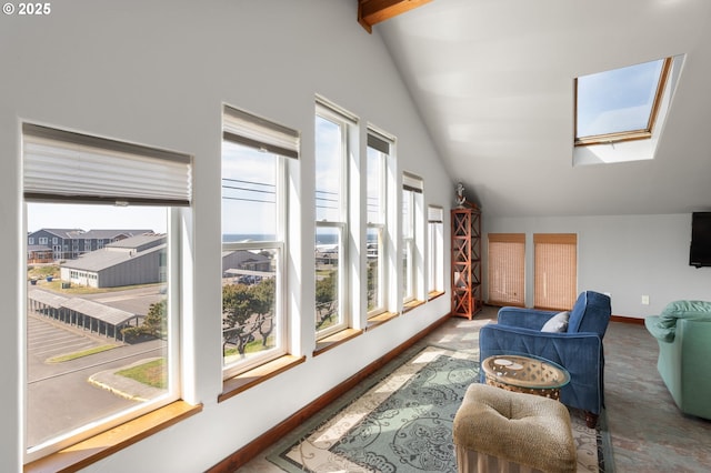 living room featuring a skylight, vaulted ceiling, and baseboards