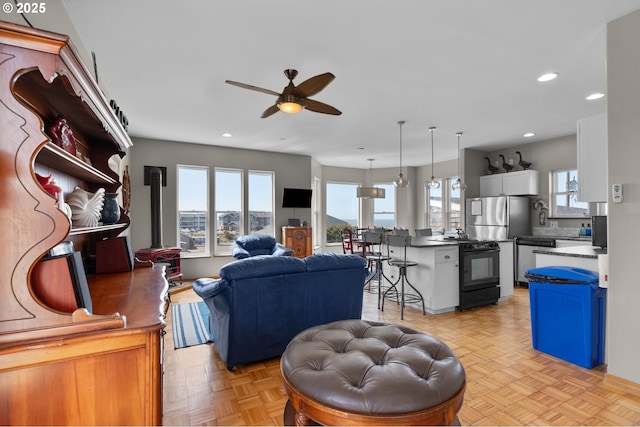 living area with a ceiling fan and recessed lighting