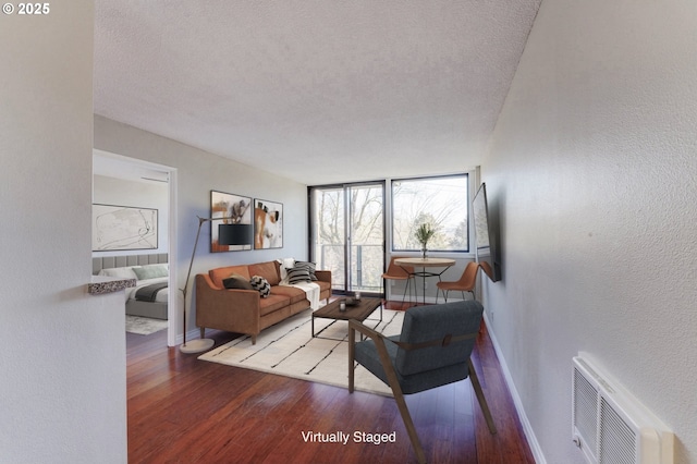 2020 SW Main St Unit 403, Portland, OR 97205 - living area with baseboards, a textured ceiling, hardwood / wood-style flooring, and a textured wall