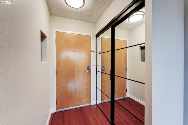 2020 SW Main St Unit 403, Portland, OR 97205 - corridor featuring wood finished floors, baseboards, and a textured ceiling