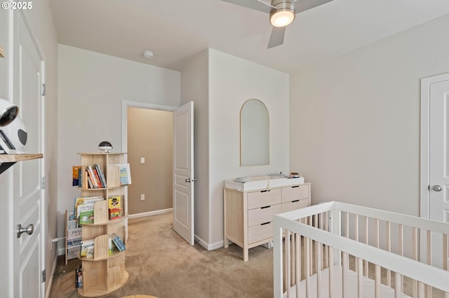 bedroom with light carpet, baseboards, and a ceiling fan