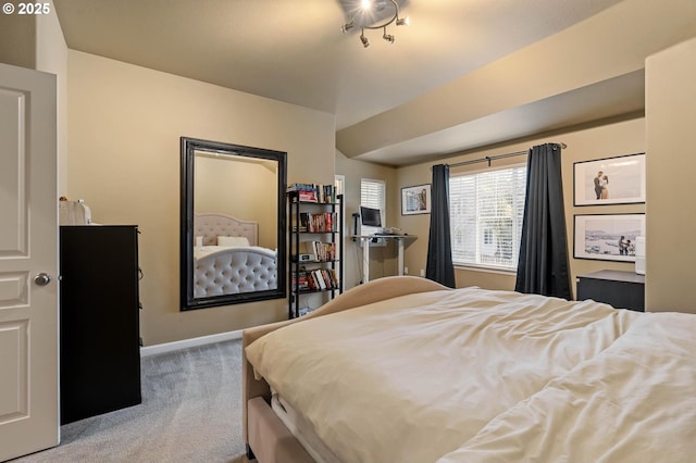 carpeted bedroom featuring baseboards