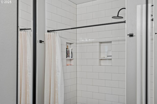 bathroom with tiled shower