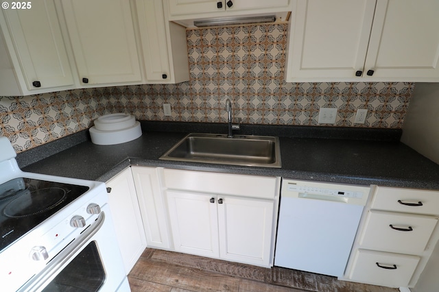 kitchen featuring white appliances, backsplash, white cabinetry, and sink