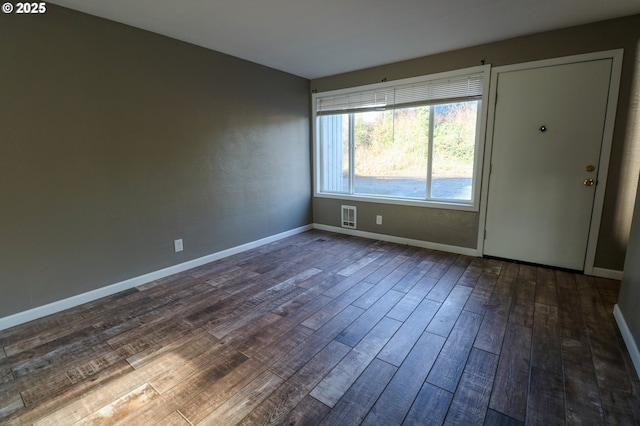 empty room with dark hardwood / wood-style flooring