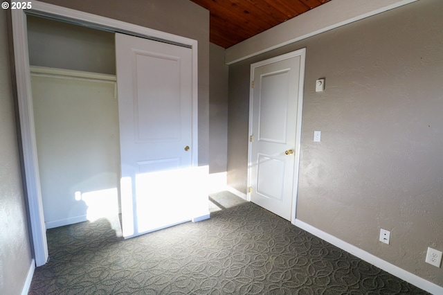 unfurnished bedroom with a closet and wood ceiling