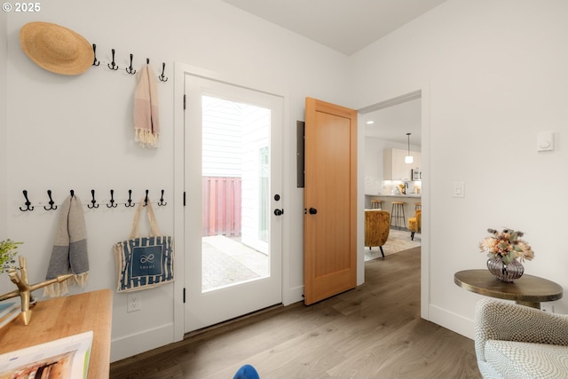 mudroom featuring light wood-style floors and baseboards