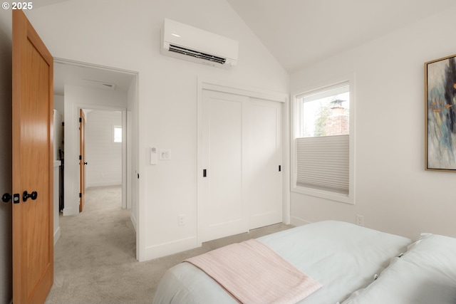 bedroom featuring light colored carpet, baseboards, vaulted ceiling, a closet, and a wall mounted air conditioner