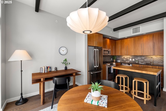 323 NW 13th Ave Unit 404, Portland, OR 97209 - dining space with beamed ceiling and wood finished floors