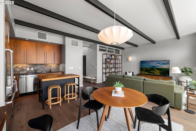 323 NW 13th Ave Unit 404, Portland, OR 97209 - dining room with beamed ceiling and dark wood-type flooring