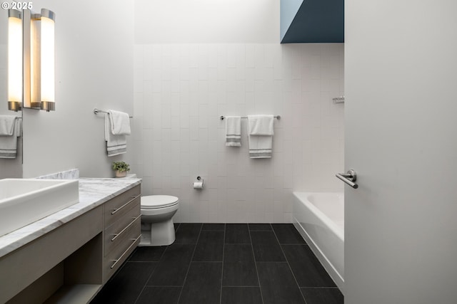 323 NW 13th Ave Unit 404, Portland, OR 97209 - full bathroom with tile patterned floors, vanity, and tile walls