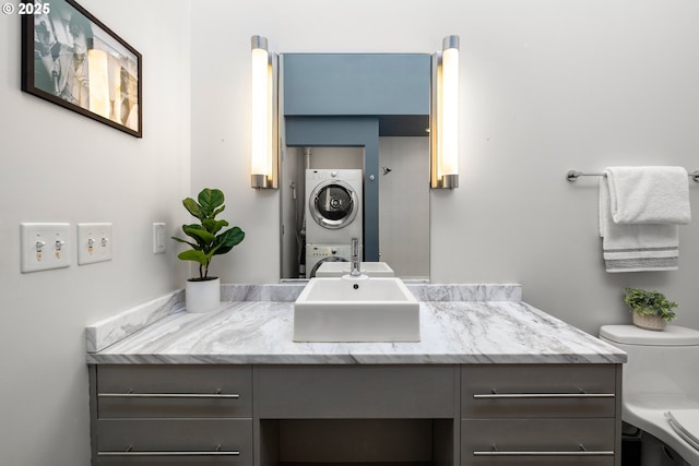 323 NW 13th Ave Unit 404, Portland, OR 97209 - bathroom featuring stacked washing machine and dryer and vanity