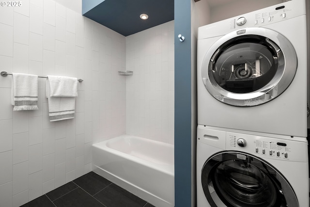 323 NW 13th Ave Unit 404, Portland, OR 97209 - washroom featuring estacked washer and dryer, dark tile patterned floors, and recessed lighting