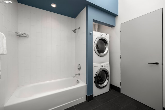 323 NW 13th Ave Unit 404, Portland, OR 97209 - bathroom with stacked washer and clothes dryer,  shower combination, and tile patterned floors