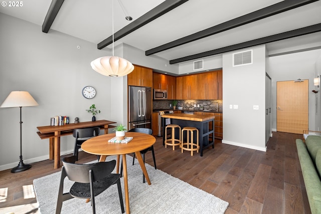 323 NW 13th Ave Unit 404, Portland, OR 97209 - dining space featuring beam ceiling and dark wood finished floors