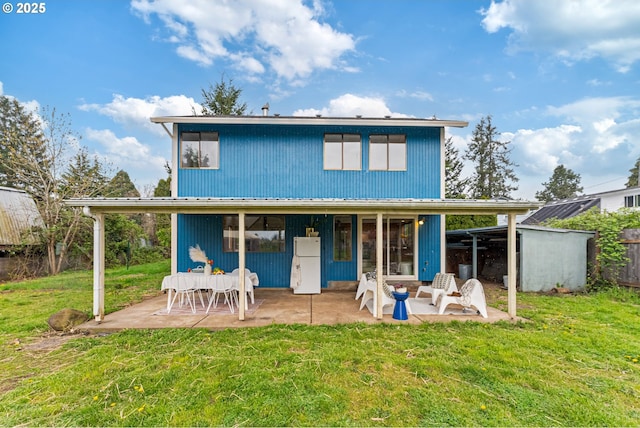 rear view of property with a patio area and a lawn