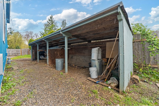 view of pole building with a detached carport and fence