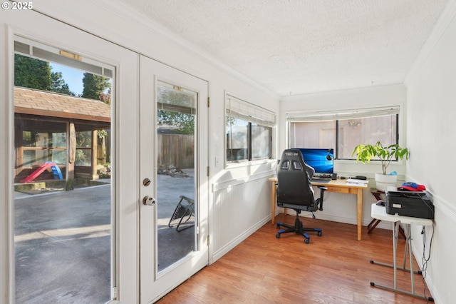 office space with crown molding, a textured ceiling, and wood finished floors