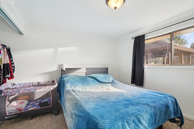 bedroom with ornamental molding and carpet