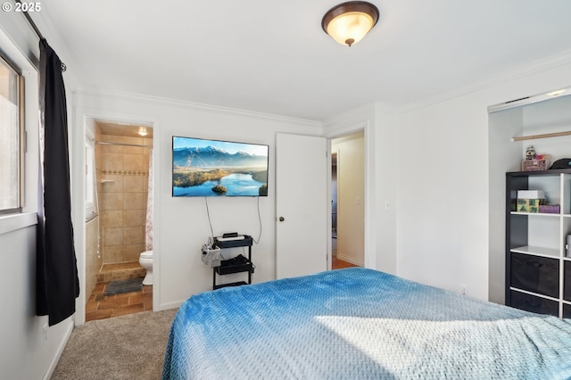bedroom with ornamental molding, connected bathroom, and carpet flooring