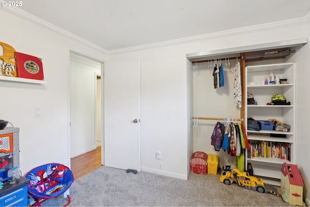 recreation room with crown molding, carpet flooring, and baseboards