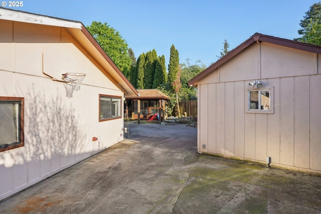 view of side of home with a patio and fence