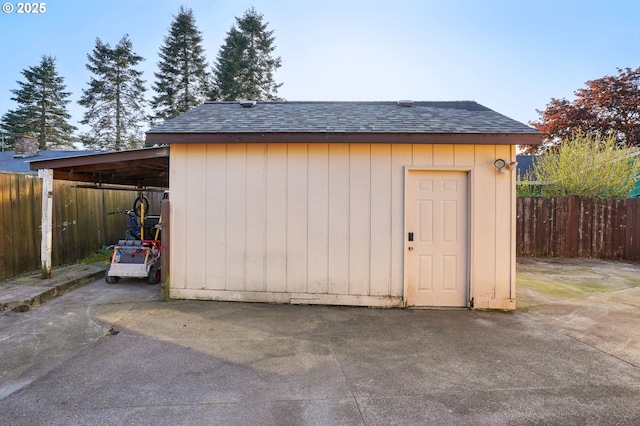 view of shed featuring fence
