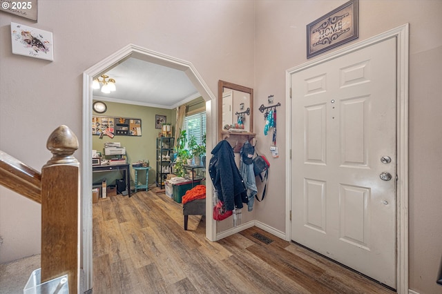 20685 SW Siletz Ct, Tualatin, OR 97062 - entryway featuring wood finished floors, ornamental molding, arched walkways, and baseboards