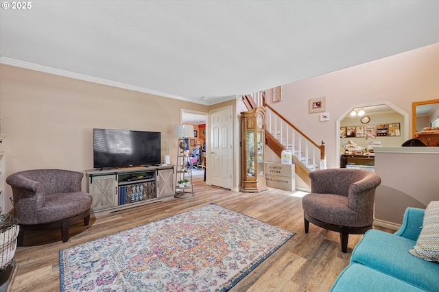 20685 SW Siletz Ct, Tualatin, OR 97062 - living room featuring stairway, wood finished floors, ornamental molding, and arched walkways