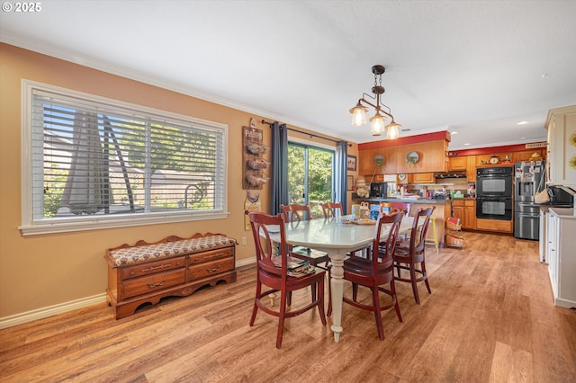 20685 SW Siletz Ct, Tualatin, OR 97062 - dining area with ornamental molding, light wood-style flooring, and baseboards
